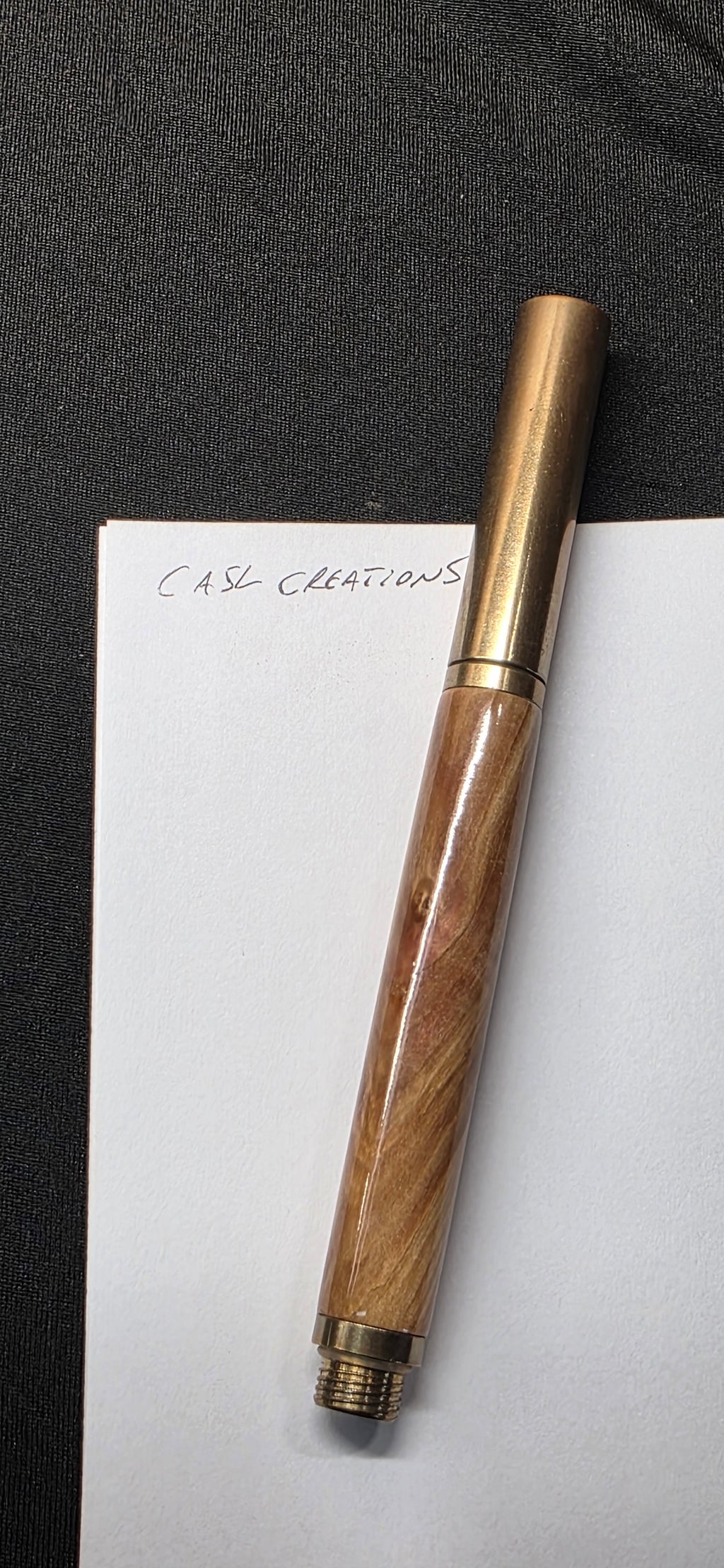 Brass raw roller ball in flame box elder